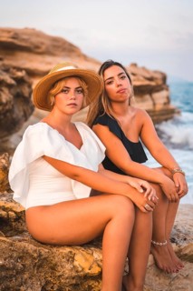 Lifestyle of a couple of Caucasian lesbian girls enjoying the summer on the beach. Black and white