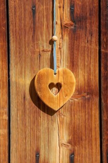 Wooden heart hanging from an alpine hut, Eng-Alm, Karwendel Mountains, Tyrol, Austria
