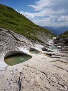 Glacier mill with glacier pots on the Trinser Alp Mora, Trin, Canton Graubünden, Switzerland