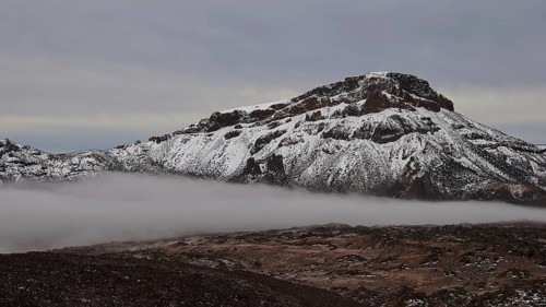 Caldera, snow-covered mountain range with fog and cloudy sky, Teide, Parque Nacional del Teide,