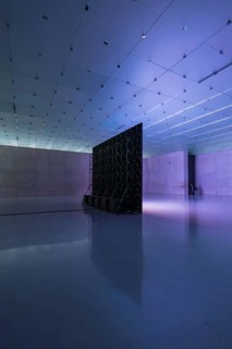 Spacious, modern room with blue and purple lighting effects, empty and industrially designed,