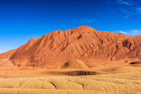 A breathtaking panoramic view of the arid, textured terrain of Devil's Desert in Salta, Argentina,