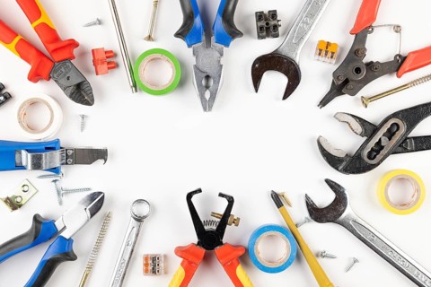 Colorful tools, tape, screws and cable connectors in circle shape on white background