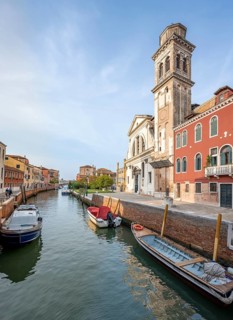 Colourful house facades and church on a canal, Venice, Veneto, Italy