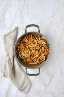 Overhead view of casserole with chopped champignon, chanterelles and oyster mushrooms