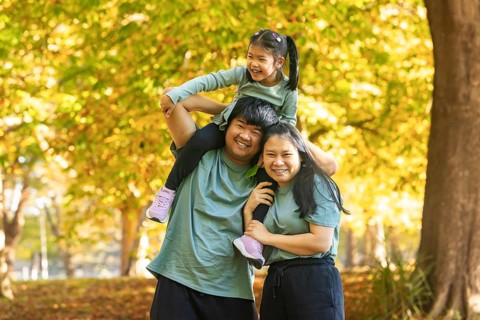 A joyful asian family enjoys a sunny day in the park, capturing precious moments of bonding. The