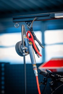 Workshop tool with air hose and compressed air accessories in front of blurred background, Waldbike