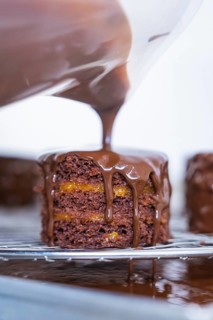 A chocolate-covered cake is on a grid in the kitchen, Vegan Tart Production, Haselstaller Hof,