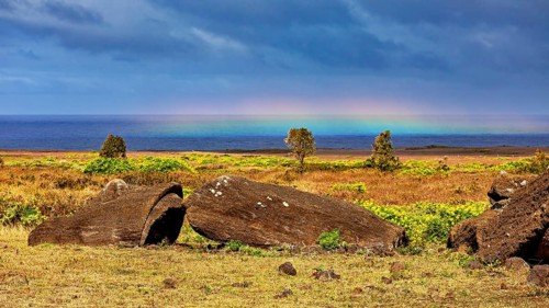Boulders in a Meadow, a Rainbow Stretching across the Sea, The Moai Statues on Easter Island in the