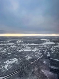 View of the snowy town of Rovaniemi with the Kemijoki river, in winter, aerial view, Finland
