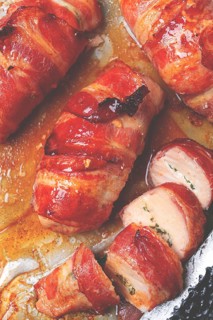 Baked chicken breast, wrapped in bacon, on a baking tray. in the home kitchen.close-up