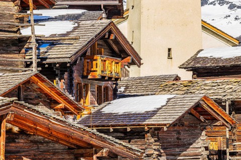 Snow-covered roofs of old farmhouses and Stadel warehouse, historic town center, Grimentz, Val