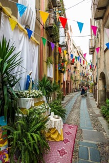 Decorated alley and colourful houses, feast of the Madonna of Regnos Altos, Bosa, district of