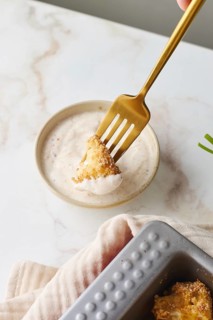 Top view of cropped unrecognizable person trying food with fork with delectable serving of baked