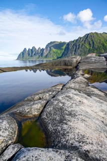 Reflection in a tidal pool, rocky coast of Tungeneset, Devil's Teeth, Okshornan, Ersfjorden, Senja