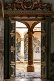 Wooden door inside an old baroque church open to its internal courtyard in Olinda, state of