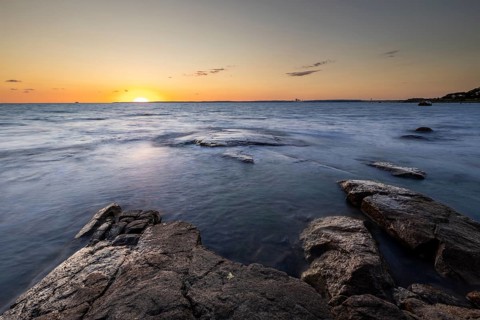 Rocks in the sea at sunset at Trönninge Stranden, Halmstad, Sweden