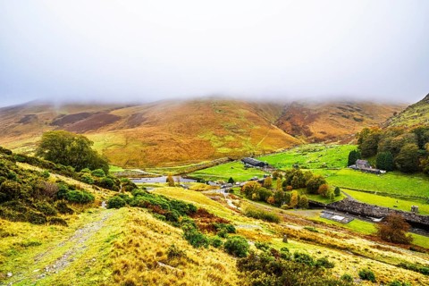 Autumn colors over Claerwen Dam, Claerwen Valley, Elan Valley Reservoir, Rhayader, Powys, Wales, UK