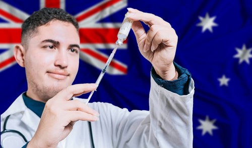 Doctor holding syringe on Australia flag background. Medical professional holding syringe with
