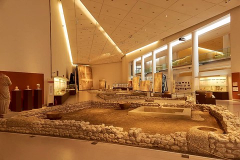 Archaeological Museum with exhibited ruins and artifacts, warmly lit, Archaeological Museum of