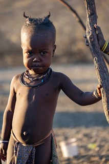 Himba child, in the morning light, traditional Himba village, Kaokoveld, Kunene, Namibia