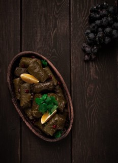Dolma (Tolma) stuffed rolls, minced meat with rice, in grape leaves, top view, no people, close-up