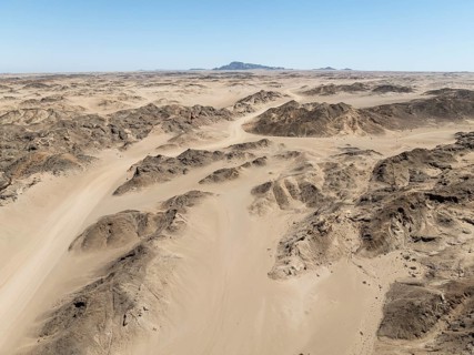 Aerial view, dry barren mountains in Moon Valley, rocky landscape ridged by erosion, Namib-Naukluft