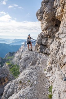 Climbers on a rock band, Bocchette Centrale band trail, via ferrata in the Brenta Mountains,