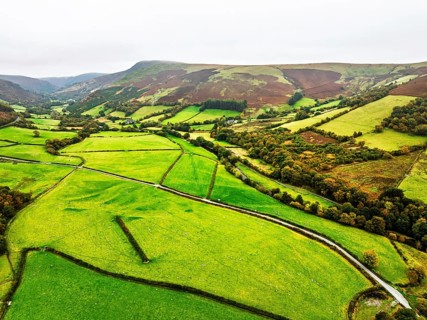 Autumn colours of Farms over River Wye and Road A470 from a drone, Llanidloes, Powys,