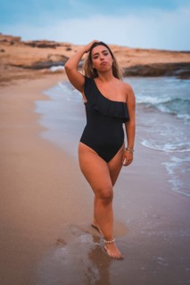 Lifestyle of a blonde Caucasian girl in a black swimsuit. Enjoying a summer afternoon on the