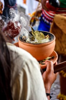 Aromatic herbs burning in a clay pot in a traditional Umbanda smoking ceremony in Brazil Belo
