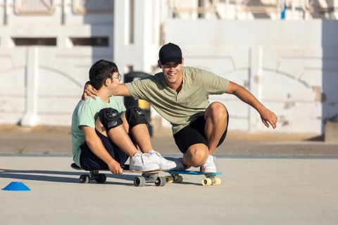 Down syndrome teenager skateboards with his brother, sharing a joyful moment and promoting