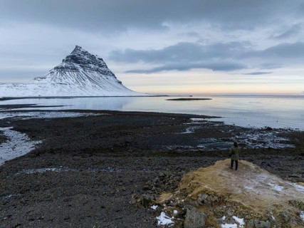 A captivating winter scene featuring Kirkjufell Mountain in Iceland. Snow blankets the mountain,