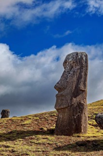 A single moai against a blue sky with clouds on Easter Island, The moai statues on Easter Island in