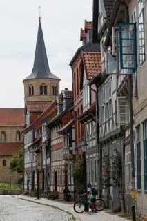 Facades of half-timbered houses in Brühlstrasse with the steeple of the Basilica of St. Godehard,