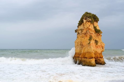 Rocks on the coast in the surf, Praia Dona Ana, Lagos, Algarve, Portugal