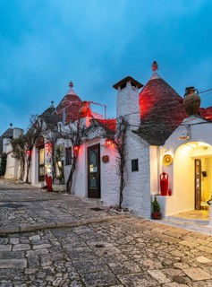 Street with Trulli houses by night, Rione Monti, Alberobello, Apulia - Puglia, Italy