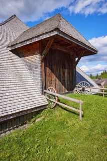 Entrance gate to a Black Forest house with old wagon wheels of the Resenhof Farm Museum in the