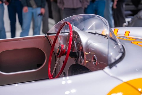 Close-up view of a vintage silver convertible car with red steering wheel, Porsche Museum,