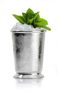 Cocktail on crushed ice in a silver cup on a white background, a few mint leaves as garnish, studio