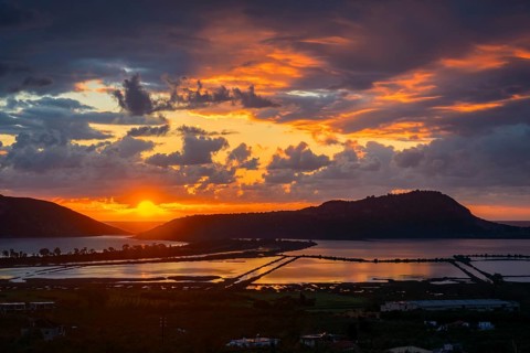 Stunning sunset over Voidokilia Beach and the Divari Lagoon of Pylos, with vivid orange and violet