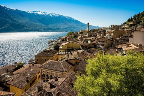Picturesque village and colorful houses on the lake and steep mountains, Limone sul Garda, Lake