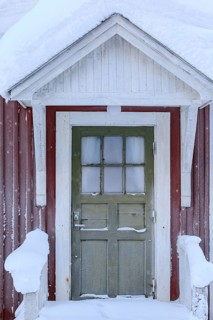 Snow-covered door, wooden house, red, cold, snow, winter, near Gällivare, Lapland, Sweden
