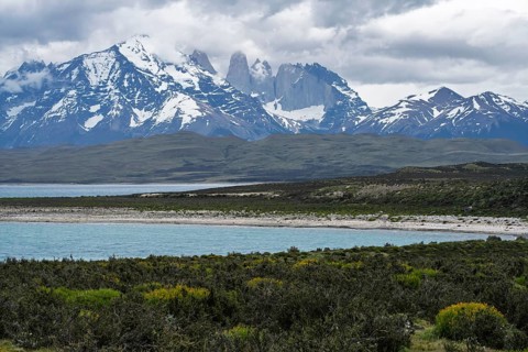 Snow-covered Cordillera del Paine massif with Torres del Paine granite towers, turquoise Lake