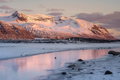 Stunning view of Iceland's winter landscape, with the snow-capped mountains of Skaftafell and a