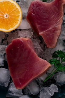 Fresh, raw steak, tuna fish, on ice, top view, close-up