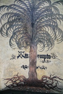 Painting in the archway, tree, trunk, roots, tree crown, pictorial representation lettering