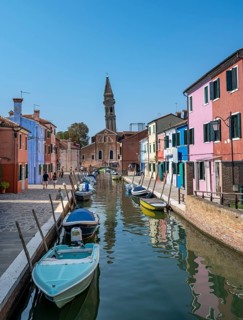 Colourful houses on the canal with reflection, canal with boats and colourful house facades, in the