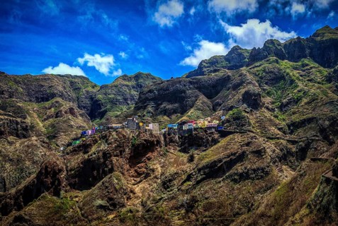 Panoramic view, small settlement, colorful village, picturesque nestled in raw, dramatic mountains