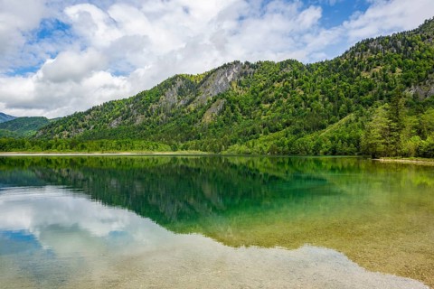 Landscape of Lake Offensee after rain when the sun comes through the clouds in spring,